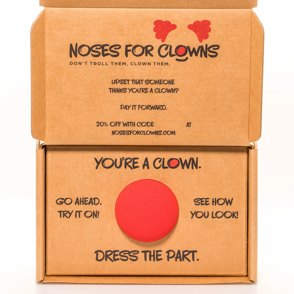 Open cardboard box with red nose and humorous text featuring “Noses for Clowns” branding on a white background.