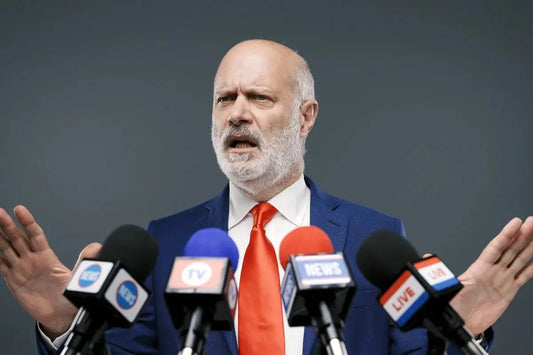 Corrupt clown politician shrugs at press mics in red tie—bald head, beard, and circus of excuses on full display!