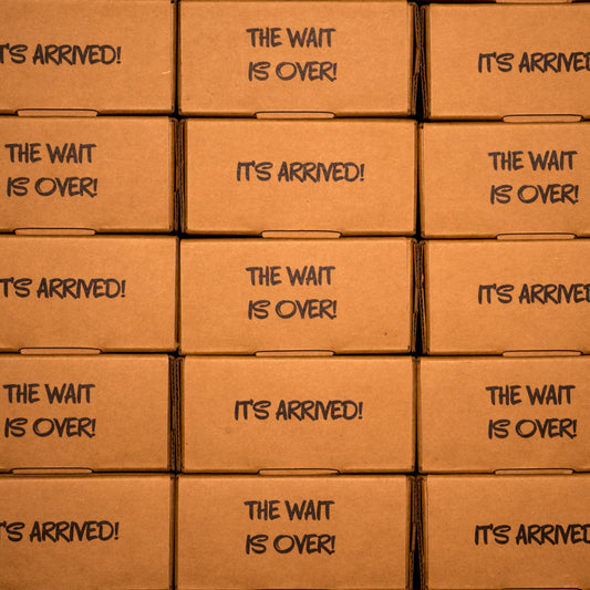 Stacked shipping boxes labeled "It's Arrived!" and "The Wait Is Over!" for Clown Nose in a Box, an anonymous prank gift