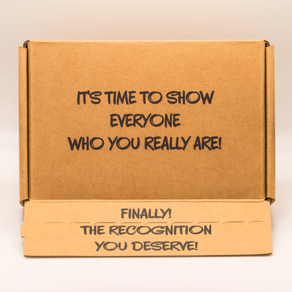 Open cardboard box with 'It’s time to show everyone who you really are!' text on the top on a white background.